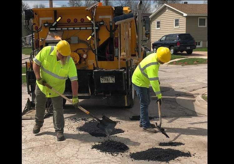 A City pothole patching crew at work.