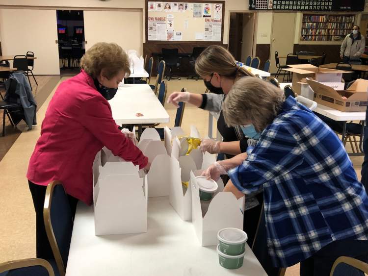 RSVP volunteers boxing up meals.