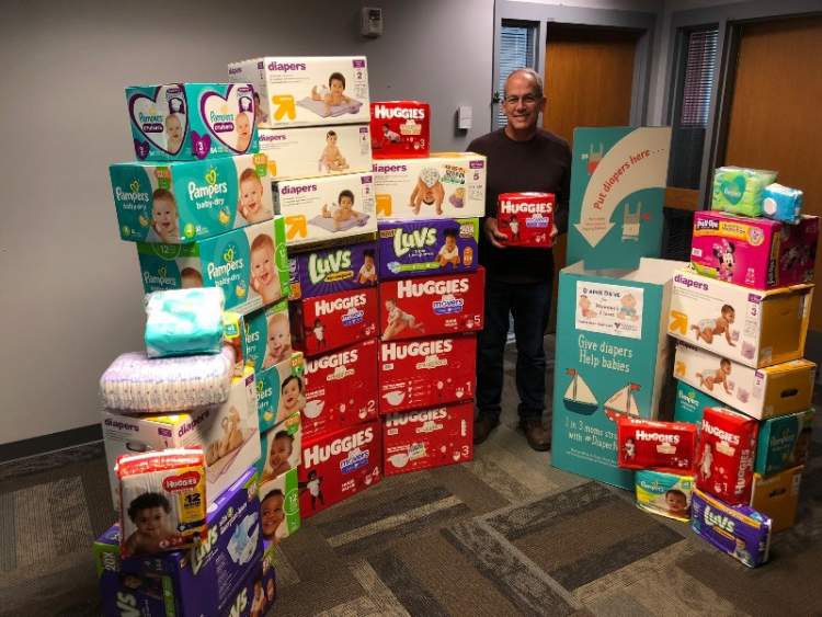 Mayor Steve Allender poses with some of the 3500 diapers collected at City Hall during the 2019 Diaper Need Awareness Week collection drive. City Hall is again serving as a collection site for diapers during this year's Diaper Need Awareness Week Sept. 21-25 and through October 2.
