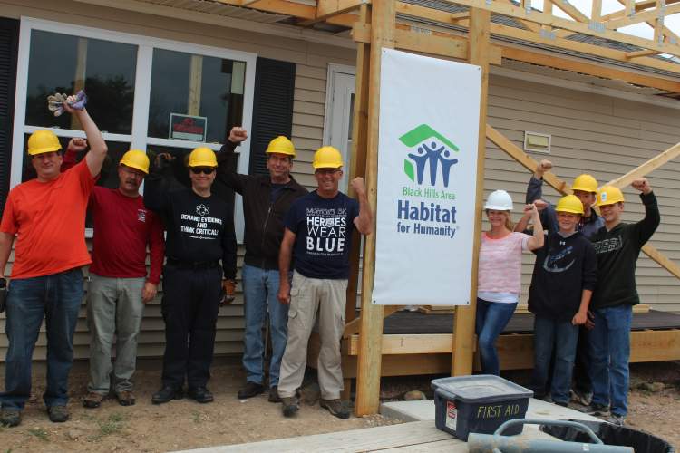 Some of the participants for the Mayor's Team Build for Black Hills Habitat for Humanity at the Garfield Green project.