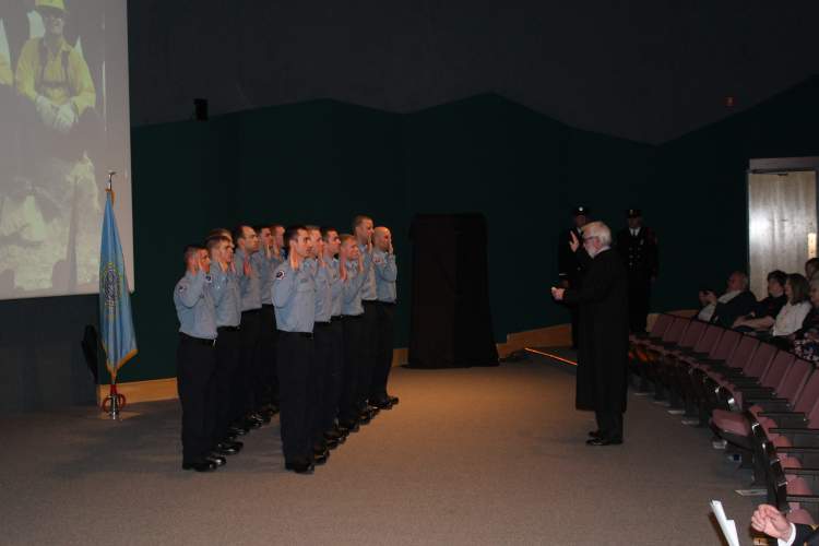 The Honorable Judge Jeff Davis presents the Firefighter Oath to a dozen recruits of the Rapid City Fire Department's Recruit Class of 2017.