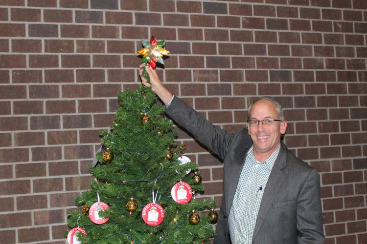 Mayor Steve Allender places a Star on top of the City's Angel Tree, located in the lobby of City Hall.  The tree contains 35 tags with suggested items for boys and girls for new, unwrapped toys.