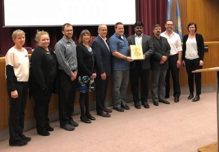 Rapid City Mayor Steve Allender and Council member Darla Drew are joined by Rapid City Area School and North Middle School officials, and Sustainability Committee members.  The Rapid City School District was presented with the Sustainability Award for the North Middle School courtyard and drainage improvement project.