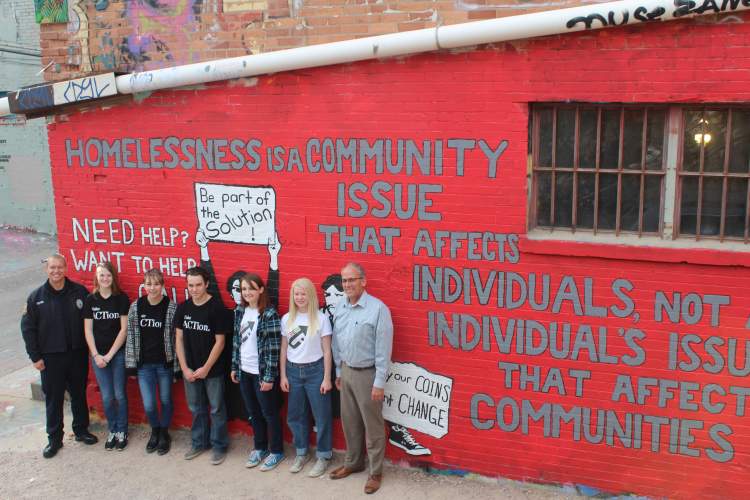 Assistant Police Chief Don Hedrick and Mayor Steve Allender join members of the Rapid City Youth Task Force in front of a new mural in Art Alley.  The mural was dedicated Monday to bring attention to the issue of homelessness in the community and nation.