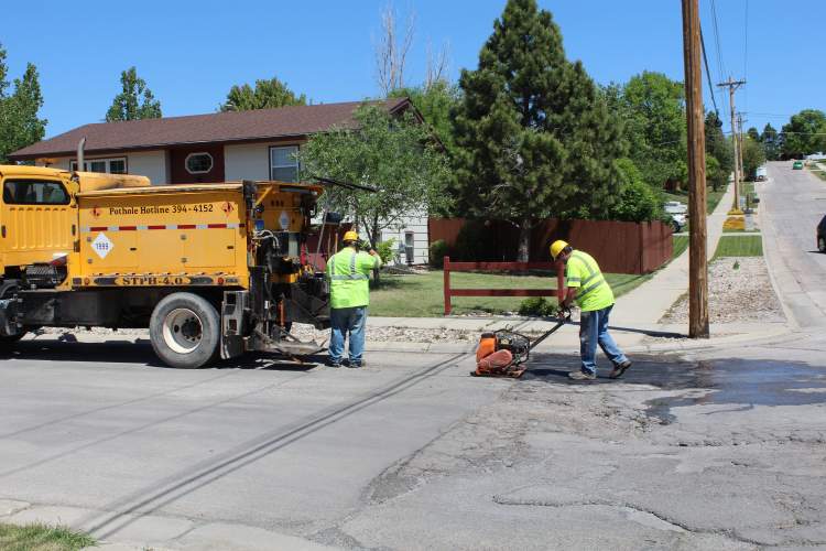 A crew from the City's Street Department fills potholes in south Rapid City.
