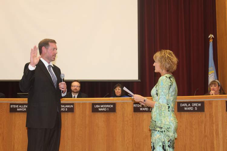 Nick Stroot is sworn in as the City's Community Resources Director by Finance Director Pauline Sumption at the October 16 City Council meeting.
