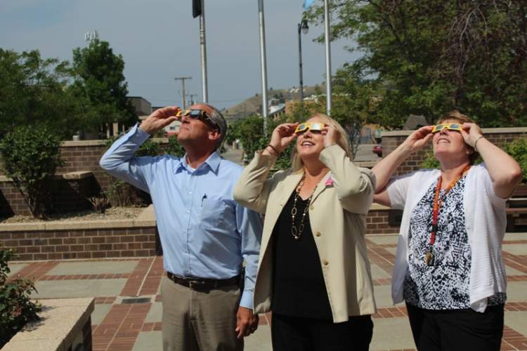 From left, Mayor Steve Allender, School Superintendent Dr. Lori Simon and Shirley Fletcher of the superintendent's office, take a good look at the Solar Eclipse.