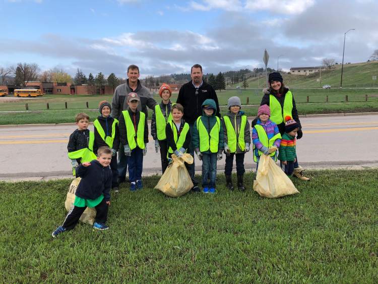 A group cleans up around the Little League fields in west Rapid City during Clean-Up Week 2019.