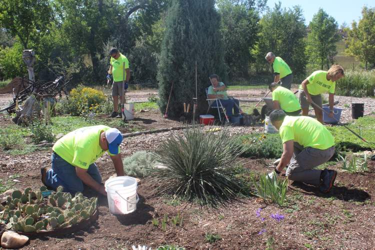 City department directors and officials perform clean-up work and winterize the educational gardens at Canyon Lake Senior Citizens Center, part of the United Way of the Black Hills' Day of Caring. 
