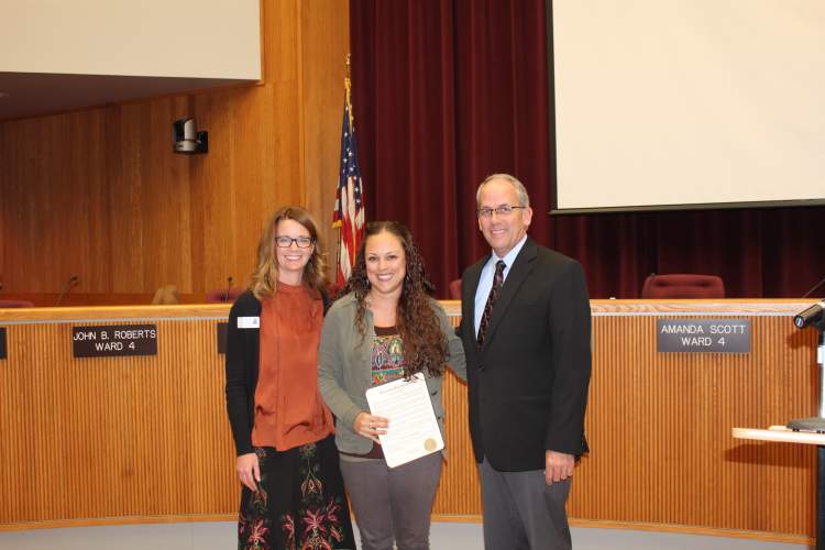 Brandi Tonkel is recognized as an 'Extra Mile Hero' by Mayor Allender and the City Council.  Pictured from left: Tanya Fritz of the Children's Home Society, Tronkel and Mayor Steve Allender.