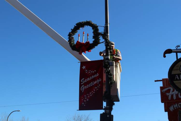 City crews are putting up wreaths, banners and lights in the downtown area and some of the City's parks in preparation for the holidays.