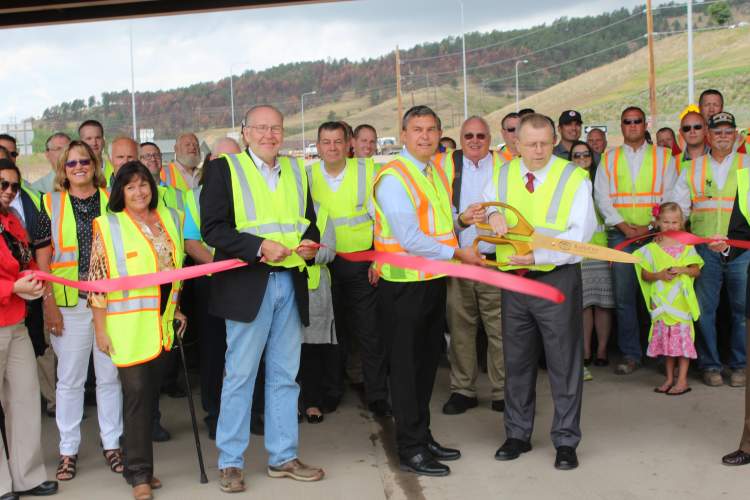 Transportation Secretary Darin Bergquist and City Public Works Director Dale Tech cut the ribbon on the I90/Silver Street Interchange project completion.